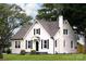 Charming home with a white exterior, black shutters, chimney, and well-manicured lawn at 330 17Th Nw St, Hickory, NC 28601