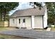 Charming exterior view of a white house with a gravel driveway and well-maintained landscaping at 330 17Th Nw St, Hickory, NC 28601