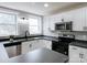 Modern kitchen featuring stainless steel appliances, white cabinetry, modern countertops, and double windows at 330 17Th Nw St, Hickory, NC 28601