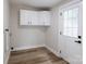 Bright room featuring laundry hook ups, white cabinets, wood floors and an exterior door at 330 17Th Nw St, Hickory, NC 28601
