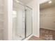 Modern bathroom with glass-enclosed shower and access to walk-in closet at 3320 Burberry Dr, Gastonia, NC 28052