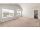 Bedroom featuring two large windows offering lots of natural light and neutral carpeting at 3334 Strong Box Ln, Gastonia, NC 28052