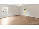 Spacious bedroom with wood flooring and natural light from two large windows at 3334 Strong Box Ln, Gastonia, NC 28052