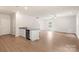 Open concept living space featuring wood flooring, breakfast bar and recessed lighting at 3334 Strong Box Ln, Gastonia, NC 28052