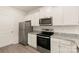 Modern kitchen with stainless steel appliances, granite countertops, and ample white cabinets at 3342 Strong Box Ln, Gastonia, NC 28052
