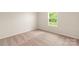 Bright bedroom features a window overlooking trees and plush carpet at 3439 Saddlebred Dr, Gastonia, NC 28052