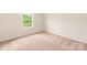 Bright bedroom features a window overlooking trees and plush carpet at 3439 Saddlebred Dr, Gastonia, NC 28052