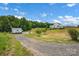 Expansive lawn leading to a large white farmhouse-style home at 355 Cal Kennedy Rd, Cleveland, NC 27013