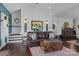 Cozy living room with a leather sofa, wainscoting, and hardwood floors at 355 Cal Kennedy Rd, Cleveland, NC 27013