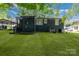Backyard view features a covered parking area and a well-maintained lawn at 3637 Glenville Rd, Charlotte, NC 28215