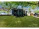 Lush backyard with covered parking and a storage shed, adding convenience and charm at 3637 Glenville Rd, Charlotte, NC 28215