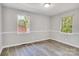 Cozy bedroom with large windows allowing natural light and new flooring at 3637 Glenville Rd, Charlotte, NC 28215