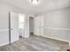 Inviting bedroom featuring updated floors, adjacent to a bathroom at 3637 Glenville Rd, Charlotte, NC 28215