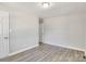 Bright bedroom with light walls and freshly installed floors at 3637 Glenville Rd, Charlotte, NC 28215