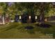 Charming single-story home with a covered front porch, lush green lawn, and mature shade trees in a desirable neighborhood at 3637 Glenville Rd, Charlotte, NC 28215