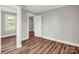 Bedroom featuring wood-look floors, a window, and a mirrored closet at 411 W Sycamore St, Lincolnton, NC 28092