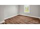 Bedroom featuring wood-look floors, a window, and light grey paint at 411 W Sycamore St, Lincolnton, NC 28092