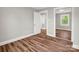 Bedroom featuring wood-look floors, a window, and a mirrored closet at 411 W Sycamore St, Lincolnton, NC 28092
