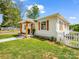 Charming home featuring a manicured lawn and a welcoming front porch at 411 W Sycamore St, Lincolnton, NC 28092