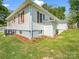 Side view of a well-maintained home with charming shutters and a manicured lawn at 411 W Sycamore St, Lincolnton, NC 28092