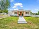 Charming single-story home featuring a well-manicured lawn, white picket fence, and inviting front porch at 411 W Sycamore St, Lincolnton, NC 28092