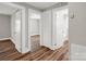 Hallway area with multiple doorways, wood-look floors, and neutral paint at 411 W Sycamore St, Lincolnton, NC 28092