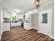 Modern kitchen featuring white cabinets, a stainless steel sink, and a view to the outdoors at 411 W Sycamore St, Lincolnton, NC 28092