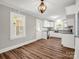 Bright kitchen with white cabinets, modern backsplash, stainless steel appliances, and ample counter space at 411 W Sycamore St, Lincolnton, NC 28092