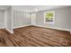 Spacious living room featuring new flooring, modern paint, and natural light at 411 W Sycamore St, Lincolnton, NC 28092