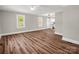 Living room features new flooring, neutral paint, and windows with outdoor views at 411 W Sycamore St, Lincolnton, NC 28092