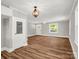 Open-concept living space with stylish lighting, a pantry door, and new vinyl flooring at 411 W Sycamore St, Lincolnton, NC 28092