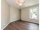 Bright bedroom with hardwood floors, neutral walls, built-in shelves and a window overlooking the neighborhood at 4315 Poplar Grove Dr, Charlotte, NC 28269
