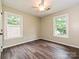 Bright bedroom with hardwood floors, neutral walls, ceiling fan, and large windows for plenty of natural light at 4315 Poplar Grove Dr, Charlotte, NC 28269