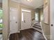 Bright foyer featuring hardwood floors, staircase, and a stylish white door with transom window at 4315 Poplar Grove Dr, Charlotte, NC 28269