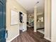 Inviting foyer with hardwood floors, modern artwork, and views to a bathroom and the living room at 4315 Poplar Grove Dr, Charlotte, NC 28269