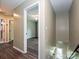 Hallway with wood floors leading to a bedroom and stairs going down, showcasing the home's layout at 4315 Poplar Grove Dr, Charlotte, NC 28269