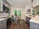 Bright eat in kitchen featuring gray cabinets, stainless appliances, and views to the exterior backyard at 4315 Poplar Grove Dr, Charlotte, NC 28269