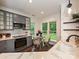 Eat in kitchen featuring gray cabinets, stainless appliances, and views to the exterior backyard at 4315 Poplar Grove Dr, Charlotte, NC 28269