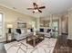 Open living room with modern furnishings, neutral tones, decorative rug, and seamless dining area access at 4315 Poplar Grove Dr, Charlotte, NC 28269
