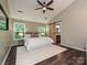 Spacious main bedroom with hardwood floors, neutral walls, and a sliding barn door to the bathroom at 4315 Poplar Grove Dr, Charlotte, NC 28269