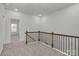 Hallway with carpeted floor and wood banister at 483 Shasta St # 5202, Gastonia, NC 28052