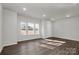 Bright, spacious living room with wood-look floors and multiple windows at 483 Shasta St # 5202, Gastonia, NC 28052