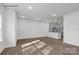 Open concept living room leading to kitchen, featuring wood-look floors at 483 Shasta St # 5202, Gastonia, NC 28052