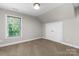 Bright bedroom featuring a large window, neutral carpeting, and closet with white double doors at 4941 Southview Dr, Hickory, NC 28602