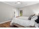 Cozy bedroom with hardwood floors, white bedding, and a view into the en-suite bathroom at 4941 Southview Dr, Hickory, NC 28602