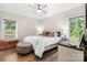 Bright bedroom features a ceiling fan, wood floors, and natural light from the windows at 4941 Southview Dr, Hickory, NC 28602