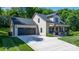 Attractive home showcasing a front-facing two-car garage and welcoming front porch with classic rocking chairs at 4941 Southview Dr, Hickory, NC 28602