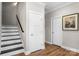 Hallway with stairs, white doors, and wood floors at 4941 Southview Dr, Hickory, NC 28602