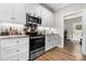 Modern kitchen with white cabinets, stainless steel appliances, and hardwood flooring at 4941 Southview Dr, Hickory, NC 28602