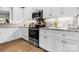 Well-equipped kitchen with stainless steel appliances, white cabinets, and granite countertops at 4941 Southview Dr, Hickory, NC 28602